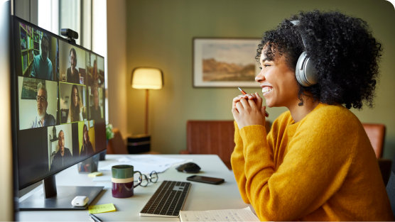 Young woman laughing on a conference video call.