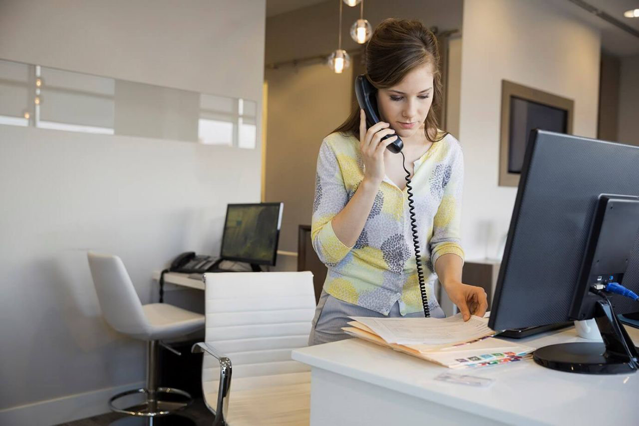 woman on phone in small office