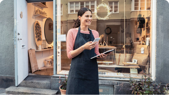 Craftswoman using her app outside her workshop.