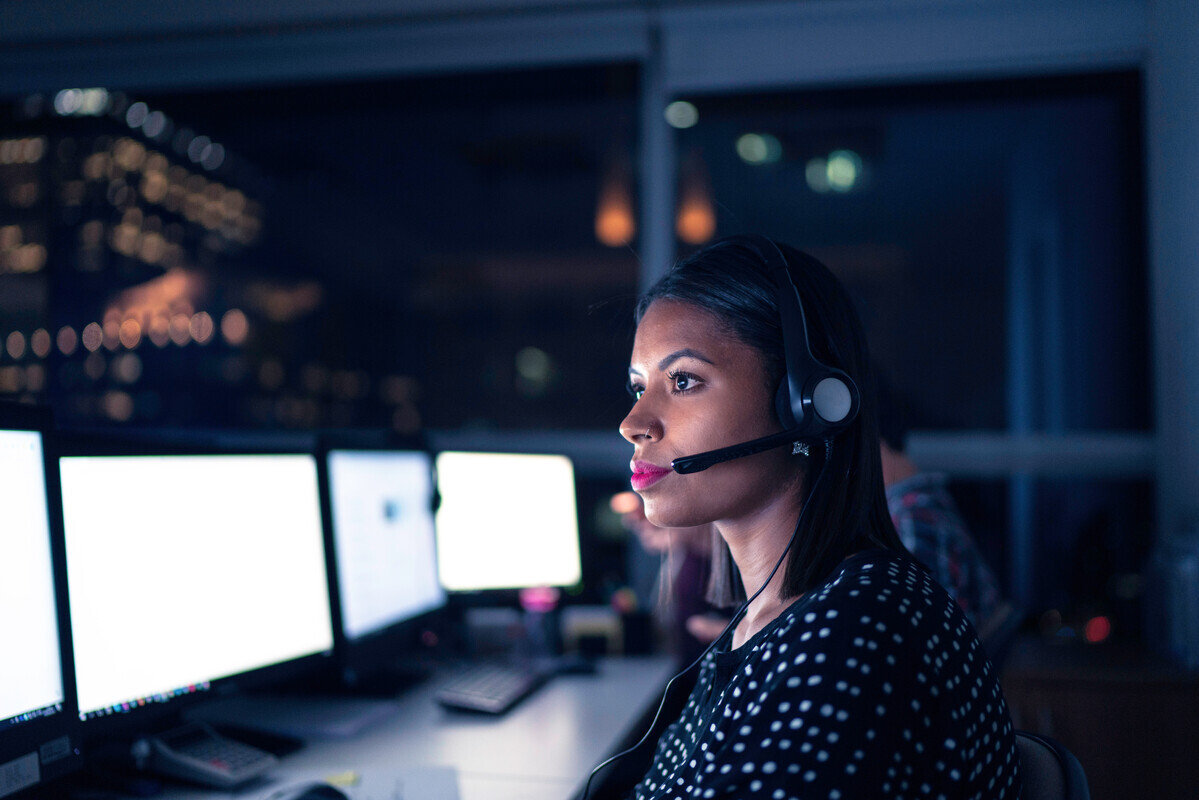 woman working in an office and talking on a headset
