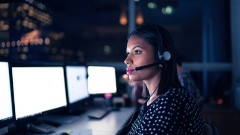 woman working in an office and talking on a headset