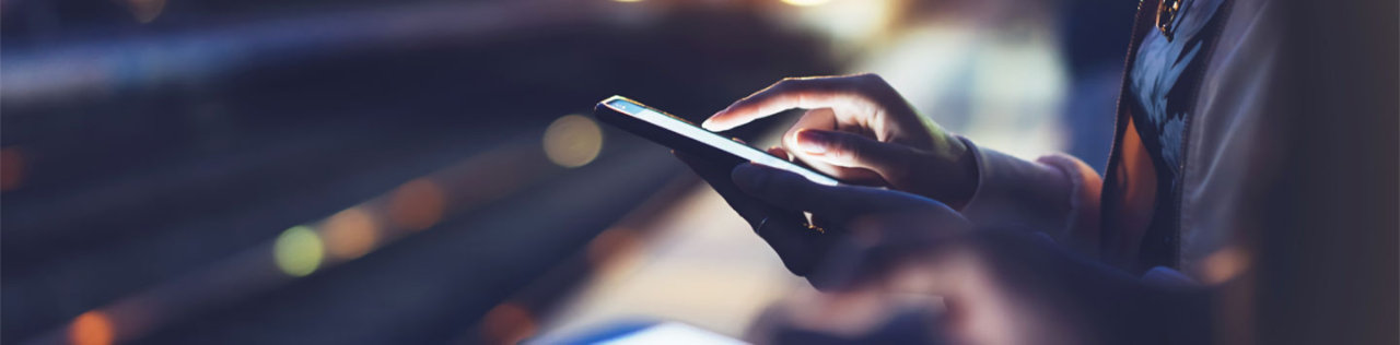 woman using mobile phone at night blurred background