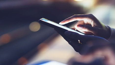 woman using mobile phone at night blurred background
