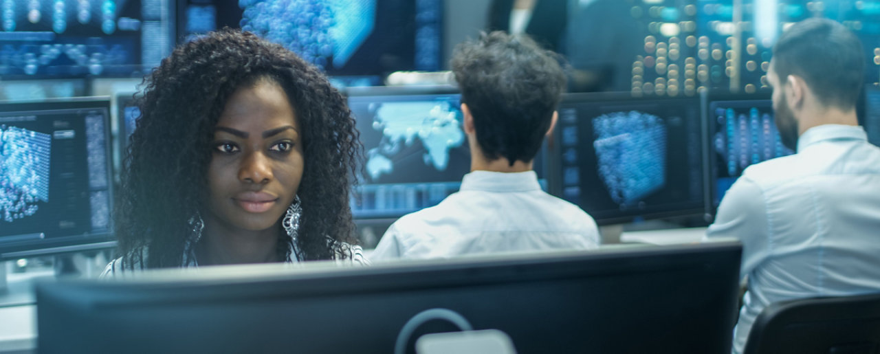 Woman working at PC analysing data