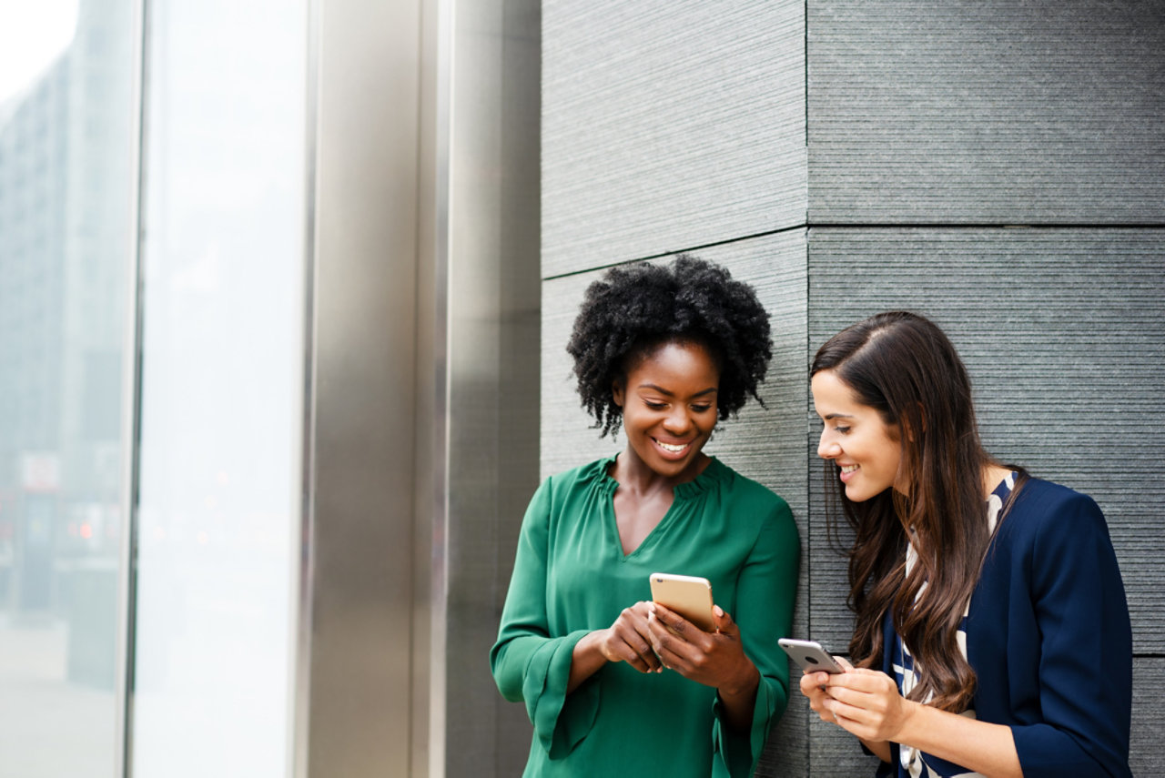 Women looking at smartphones