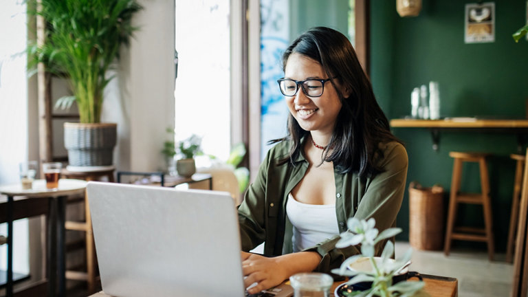 young woman working on a laptop in a cafe